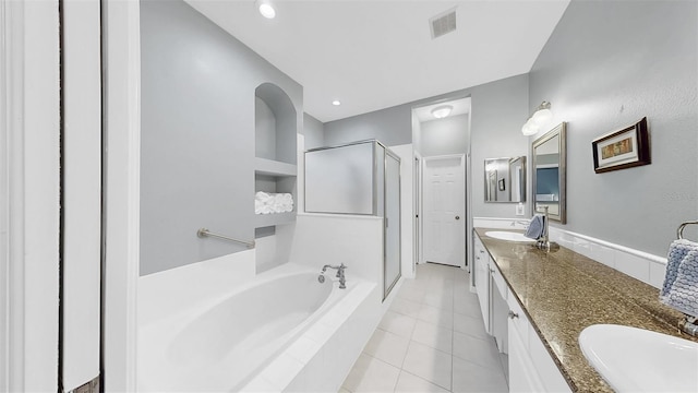 full bathroom with a sink, visible vents, a shower stall, a bath, and double vanity