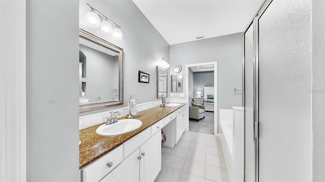 bathroom featuring tile patterned flooring, visible vents, a sink, and double vanity