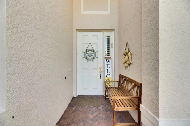 view of exterior entry featuring stucco siding