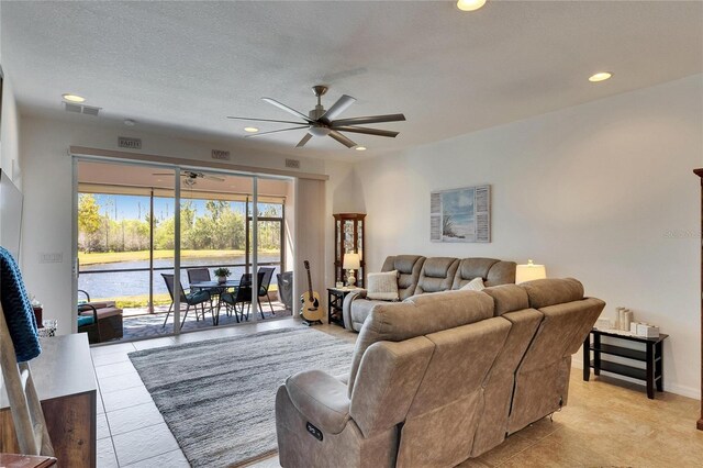 living area with visible vents, recessed lighting, a textured ceiling, and ceiling fan