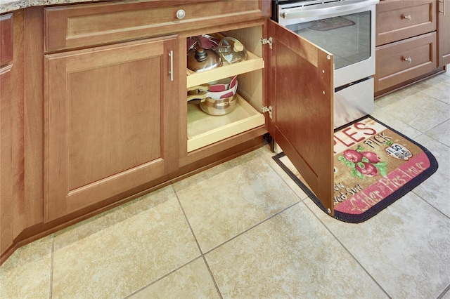 room details with stainless steel stove and brown cabinetry