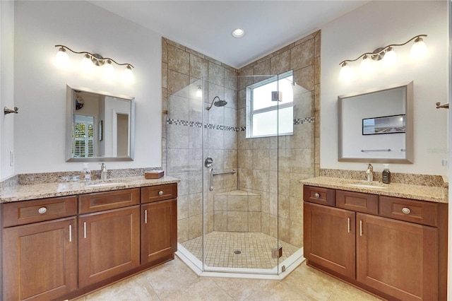 full bathroom with tile patterned floors, a shower stall, and a sink