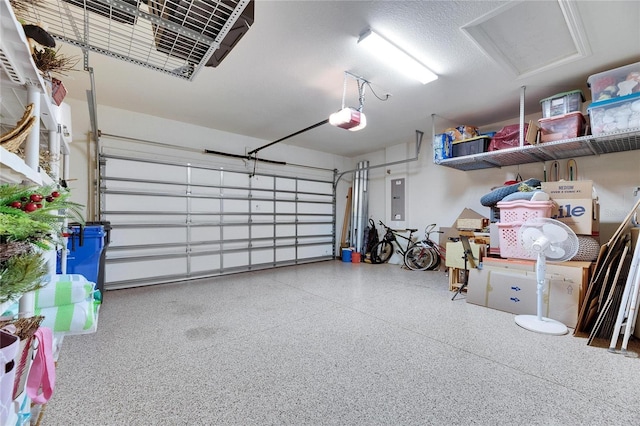 garage featuring electric panel and a garage door opener