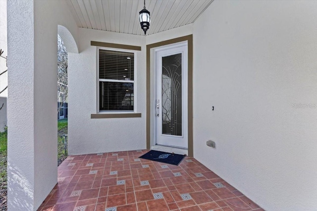 property entrance featuring stucco siding