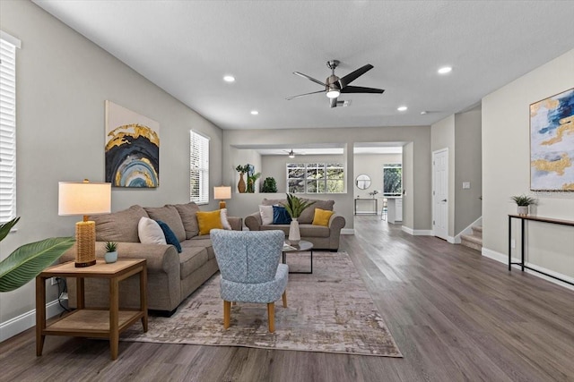 living room featuring wood finished floors, baseboards, recessed lighting, ceiling fan, and stairs