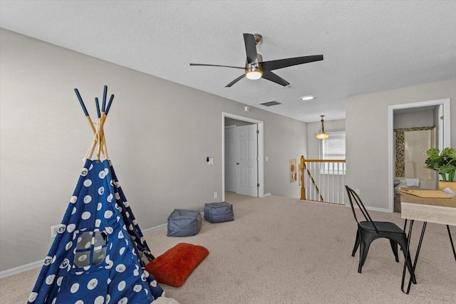 home office with baseboards, visible vents, a textured ceiling, and carpet