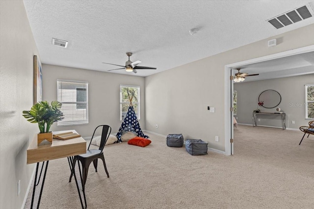 office featuring visible vents, carpet floors, and a textured ceiling