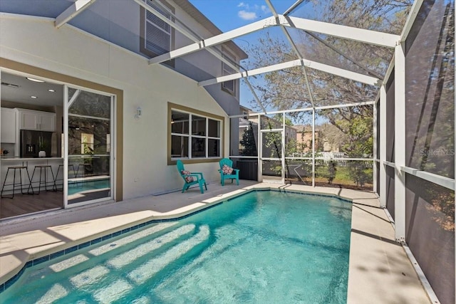 outdoor pool featuring a patio and a lanai