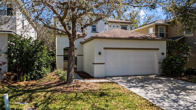 view of front of house featuring a garage, driveway, and stucco siding