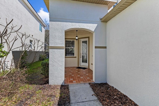 property entrance featuring stucco siding