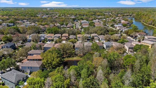 birds eye view of property featuring a residential view, a wooded view, and a water view