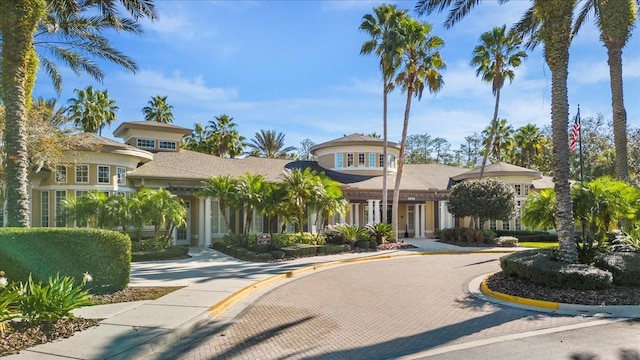 view of building exterior with curved driveway