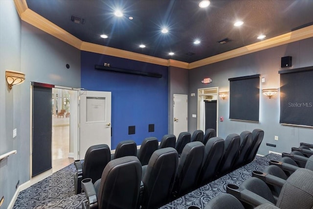 cinema room featuring visible vents, a towering ceiling, and ornamental molding