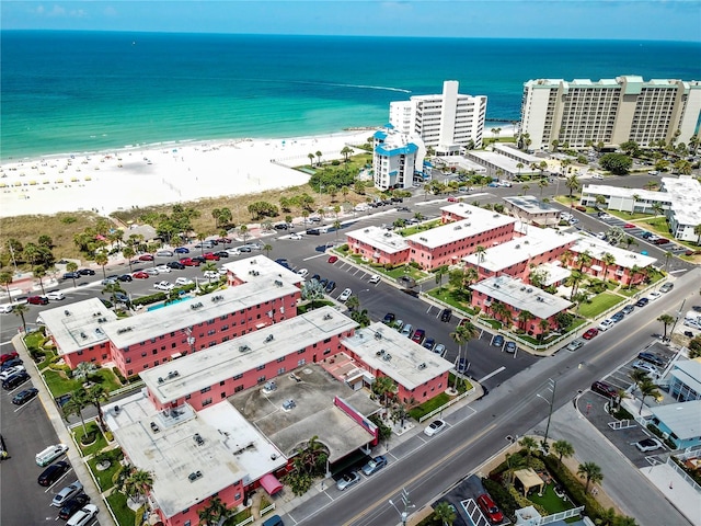 birds eye view of property with a view of city, a beach view, and a water view