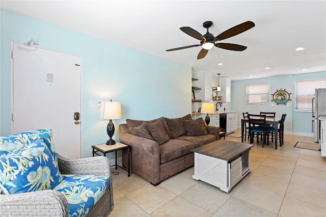 living area with a ceiling fan, light tile patterned floors, recessed lighting, and baseboards