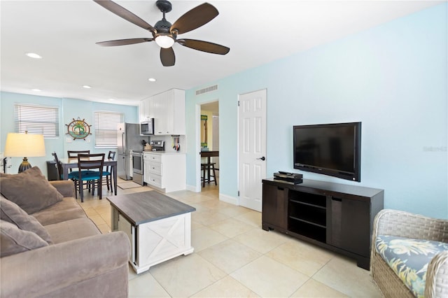 living area with light tile patterned floors, visible vents, and recessed lighting