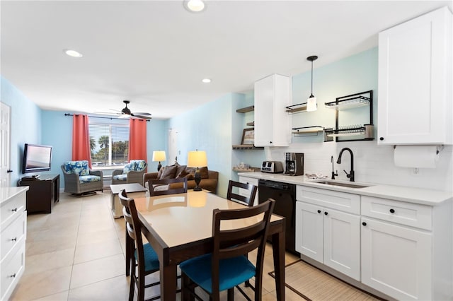 kitchen featuring open shelves, a sink, light countertops, dishwasher, and backsplash