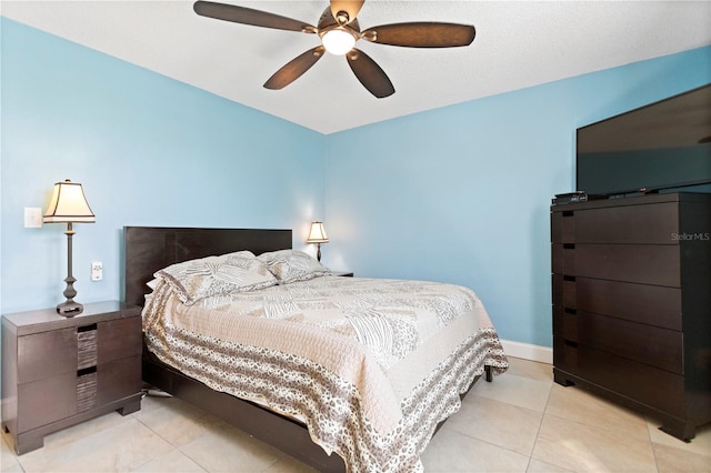 bedroom featuring light tile patterned flooring, a ceiling fan, and baseboards