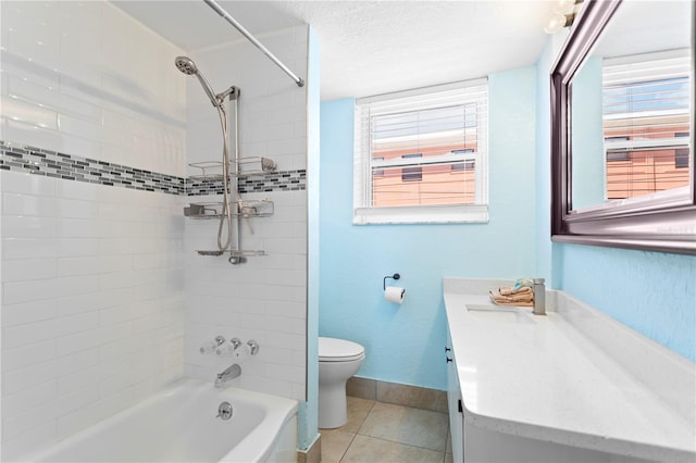 bathroom with tile patterned floors, toilet, plenty of natural light, baseboards, and vanity