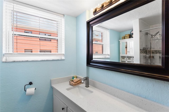 bathroom with vanity and walk in shower