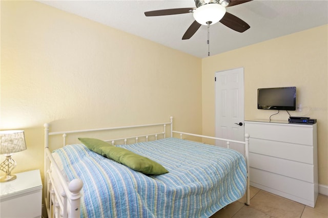 bedroom with tile patterned floors and a ceiling fan