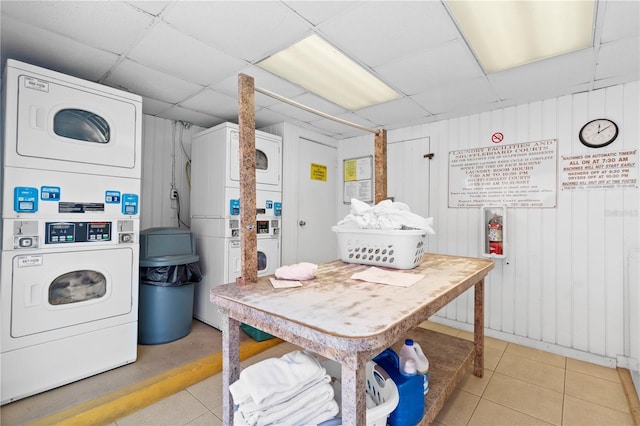 kitchen featuring a paneled ceiling, stacked washer and dryer, and tile patterned flooring