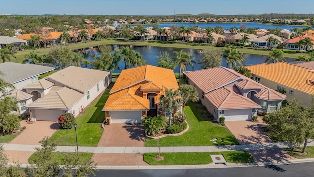 drone / aerial view with a residential view and a water view