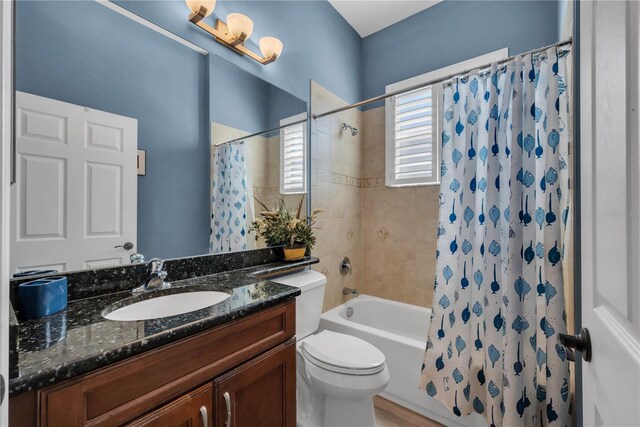 full bathroom featuring toilet, vanity, and shower / tub combo