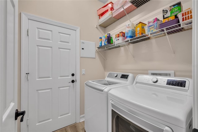 washroom with washer and clothes dryer, laundry area, and light wood-style flooring