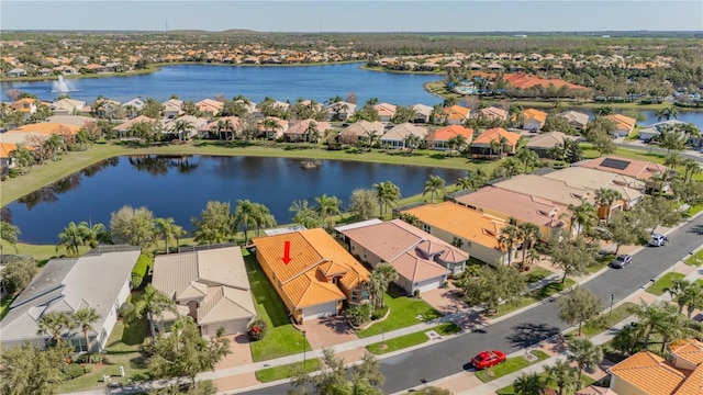 drone / aerial view featuring a residential view and a water view