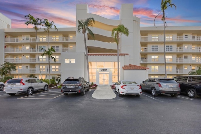 property at dusk with uncovered parking