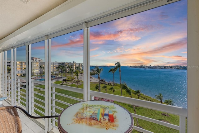 sunroom / solarium with a water view