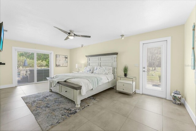 bedroom with access to exterior, baseboards, and tile patterned floors