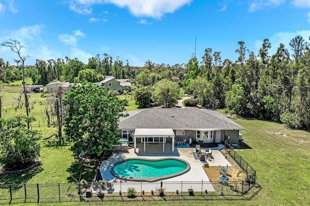 view of swimming pool featuring a yard, a patio area, a fenced in pool, and a fenced backyard