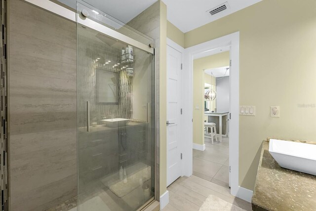 full bath with visible vents, a shower stall, baseboards, tile patterned floors, and vanity