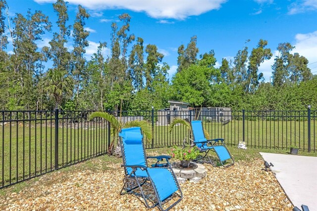 view of yard featuring fence and an outdoor fire pit