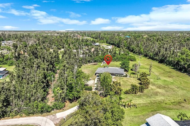 bird's eye view with a wooded view