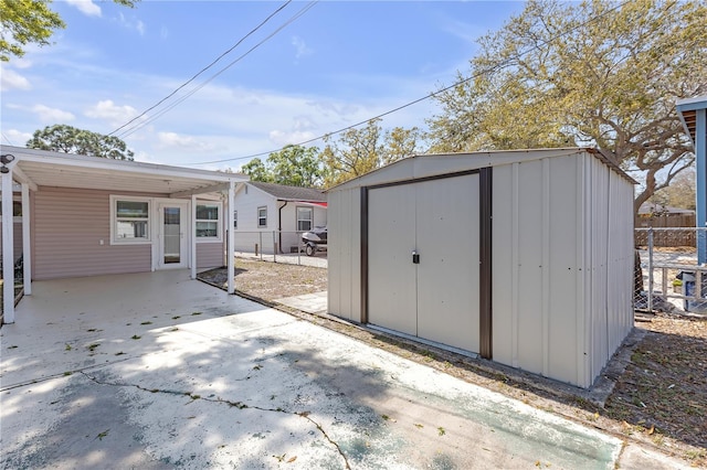 view of shed featuring fence