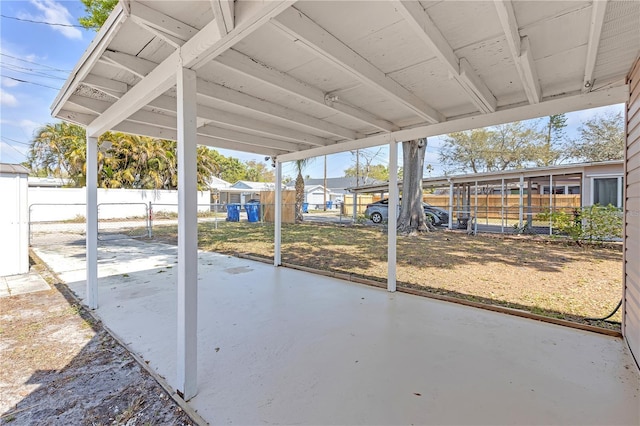 view of patio / terrace featuring a carport and fence