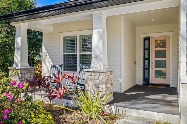 view of exterior entry featuring a porch