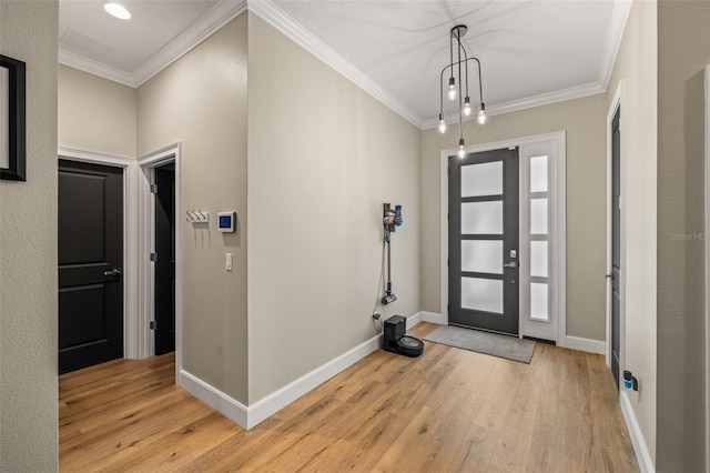 entryway featuring light wood-type flooring, baseboards, and crown molding