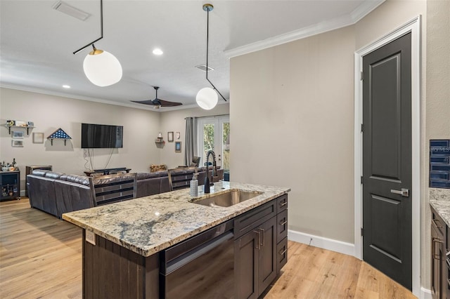 kitchen with dishwasher, crown molding, and a sink