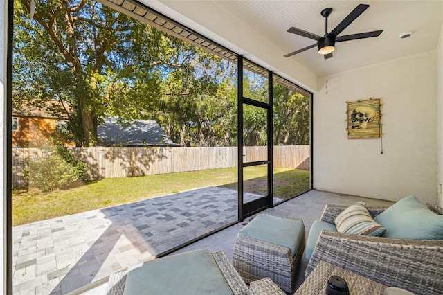 sunroom with a ceiling fan