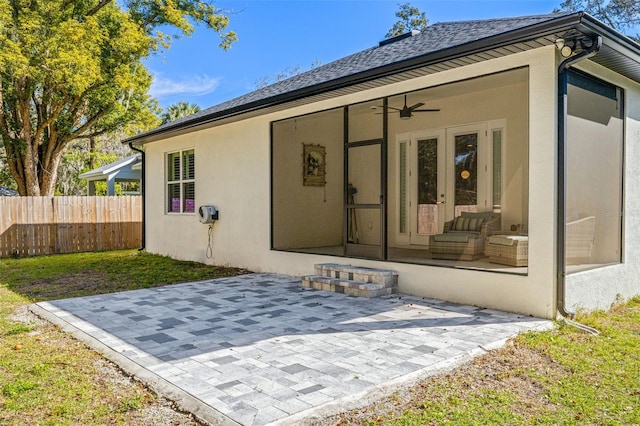 exterior space featuring stucco siding, a patio area, ceiling fan, and fence