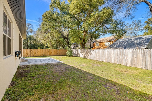 view of yard featuring a patio area and a fenced backyard