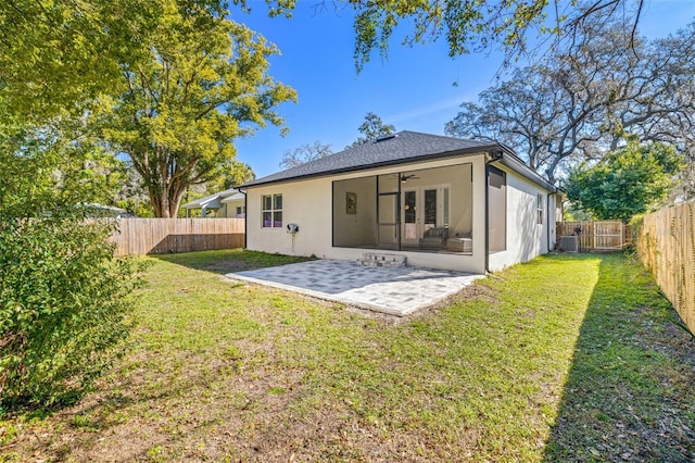 back of property with a yard, a patio, a fenced backyard, and a ceiling fan