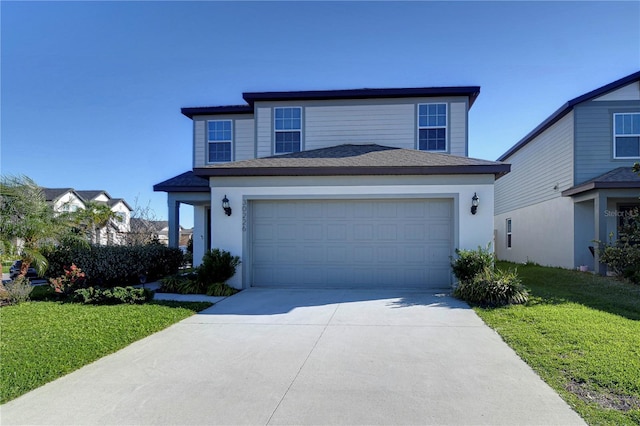 traditional-style home with stucco siding, driveway, a shingled roof, an attached garage, and a front yard