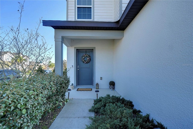 property entrance featuring stucco siding