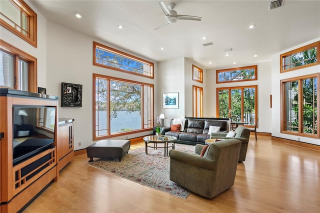 living area featuring recessed lighting, visible vents, baseboards, and light wood finished floors