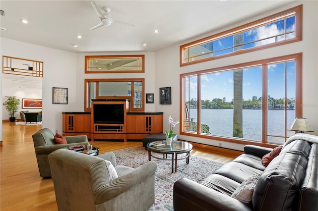 living room featuring recessed lighting, a ceiling fan, and light wood finished floors